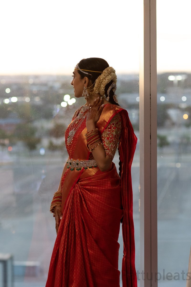 South Indian bride in red Kanjeevaram silk saree with heavy maggam embroidered bridal blouse